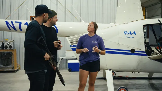 Georgia Tucker of Cedar Ridge Aviation briefs Tommy and Josh beside the helicopter before the hog hunt.