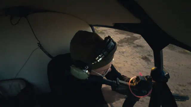 Josh aims a rifle from the open door of a helicopter during the feral hog hunt in Texas.