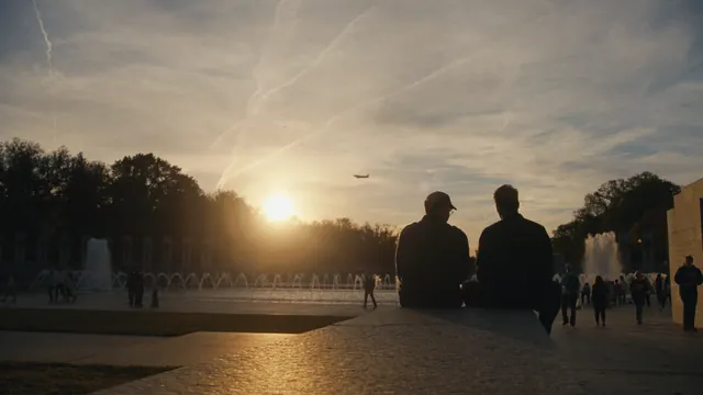 Josh and Tommy watch the sun set over the National Mall in Washington, DC.