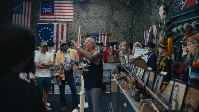 Mel Bernstein leads Josh and Tommy through his military museum in Colorado Springs.