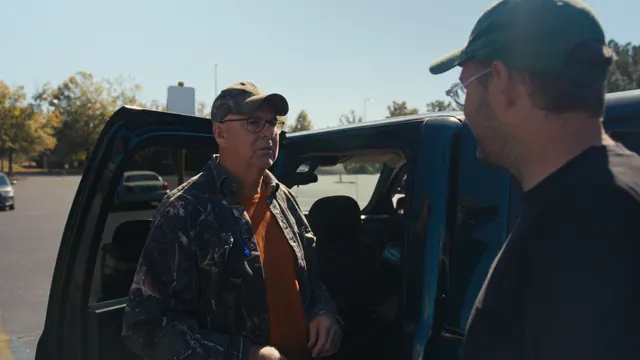 A man talks with Josh beside his pickup in Pell City, Alabama.