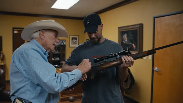 Sheriff Parnell McNamara shows Tommy a scoped rifle, moments before they find a live round in the chamber.
