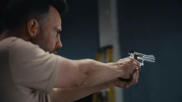 Tommy aims a prop revolver during armourer Dutch Merrick's firearms safety course in Los Angeles.