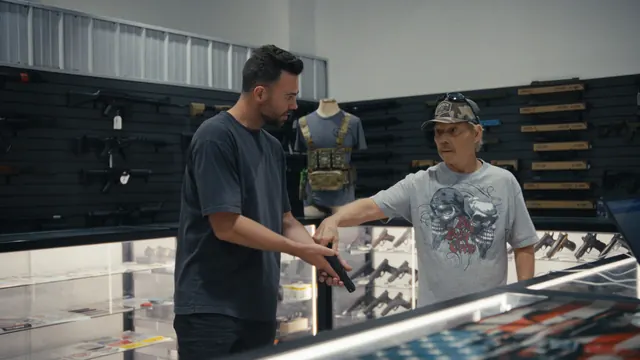 Raymond Erickson shows Tommy how to check his new pistol at a gun shop near the Utah–Nevada border.